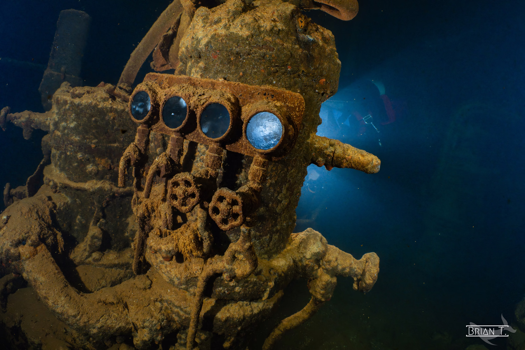 An engine-room telegraph and gauges encrusted on a Truk wreck