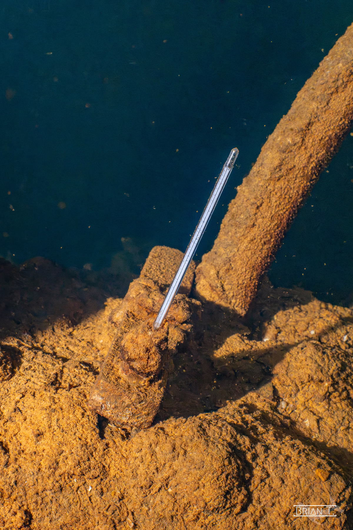 A glass thermometer resting intact on the wreckage of a Truk Lagoon ship