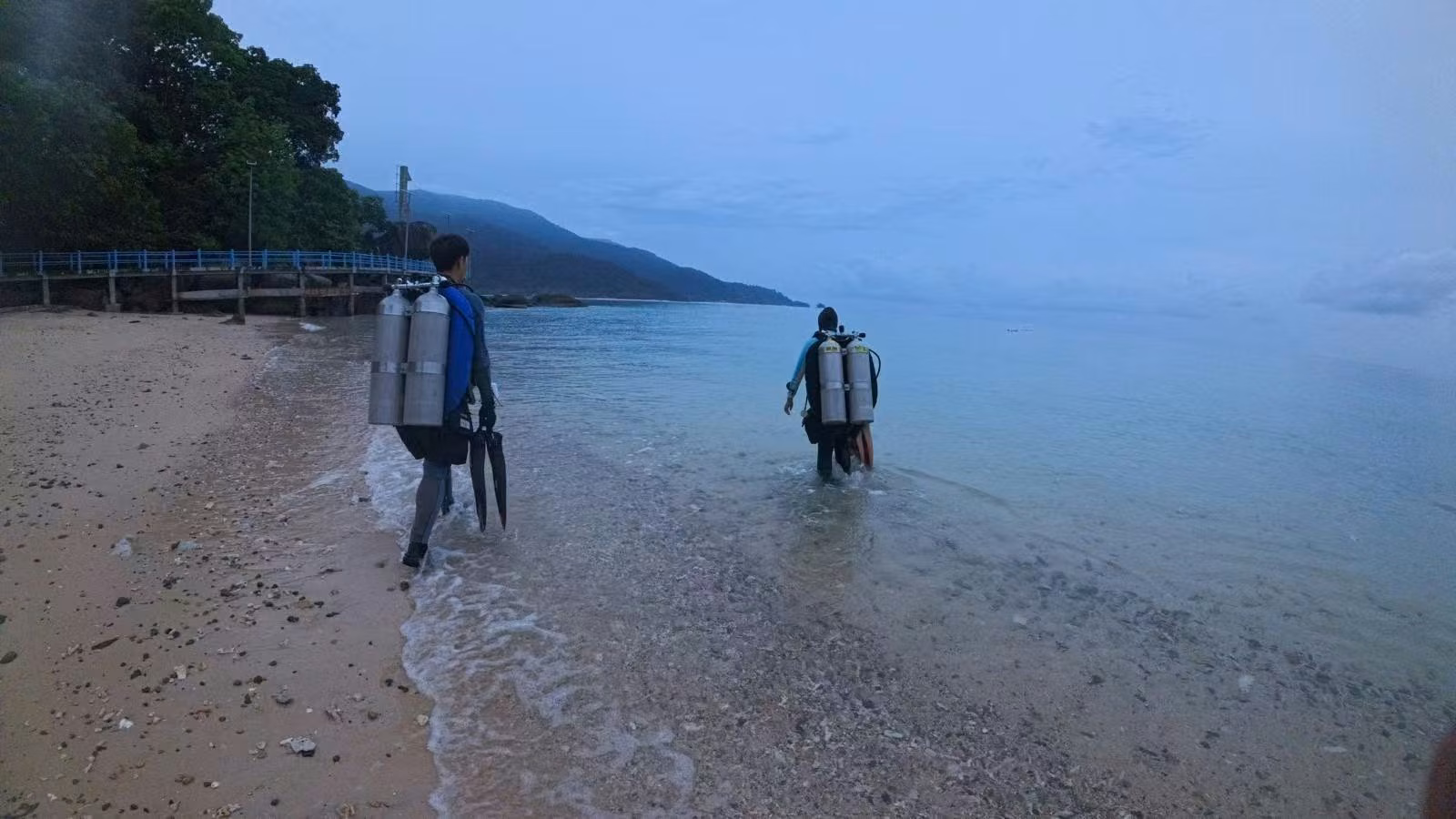 Team entering the water at Marine Park Bay, Tioman